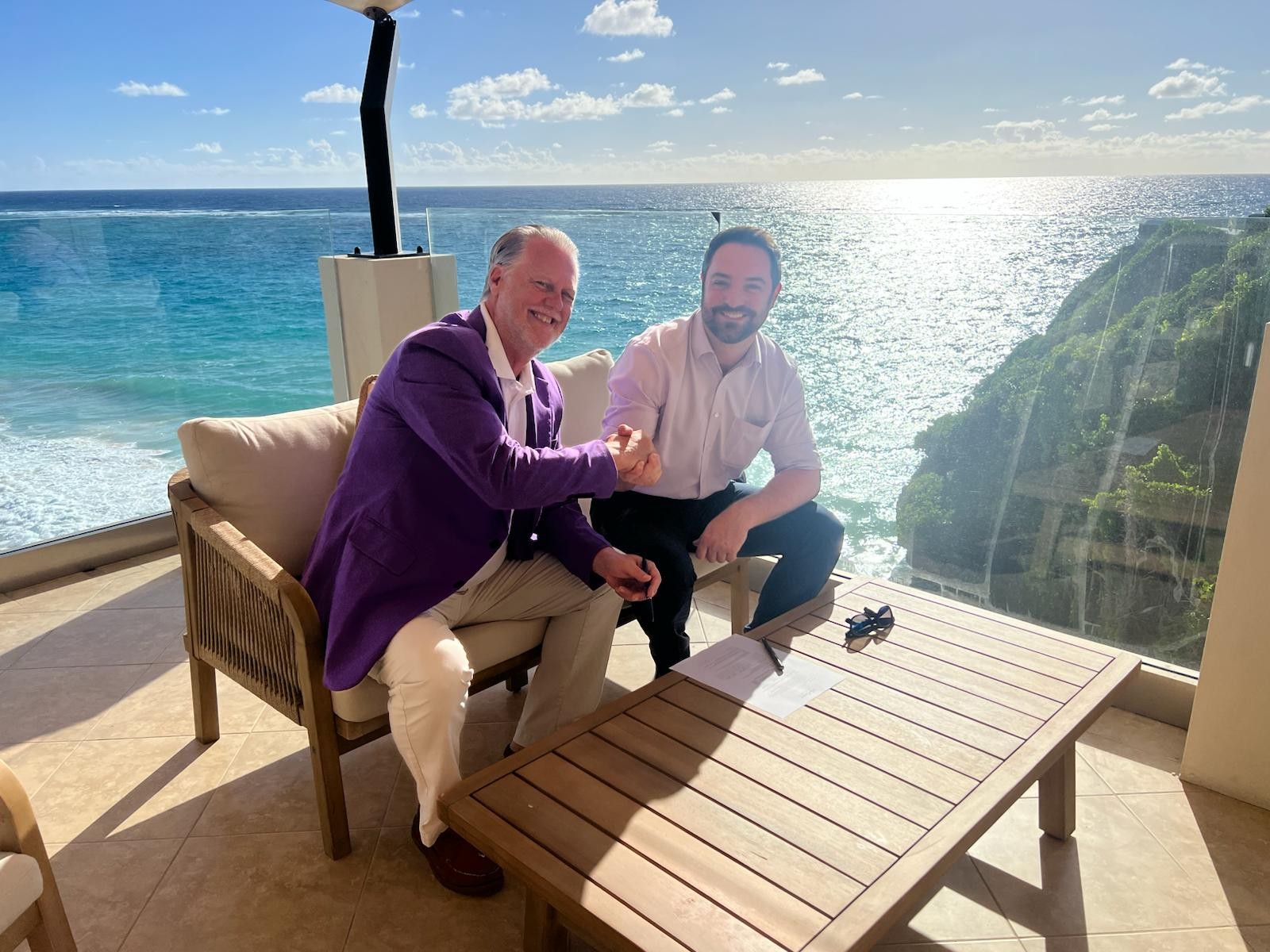 Image of Greg Hill and Jamie Allen signing the partnership agreement in Barbados. 
